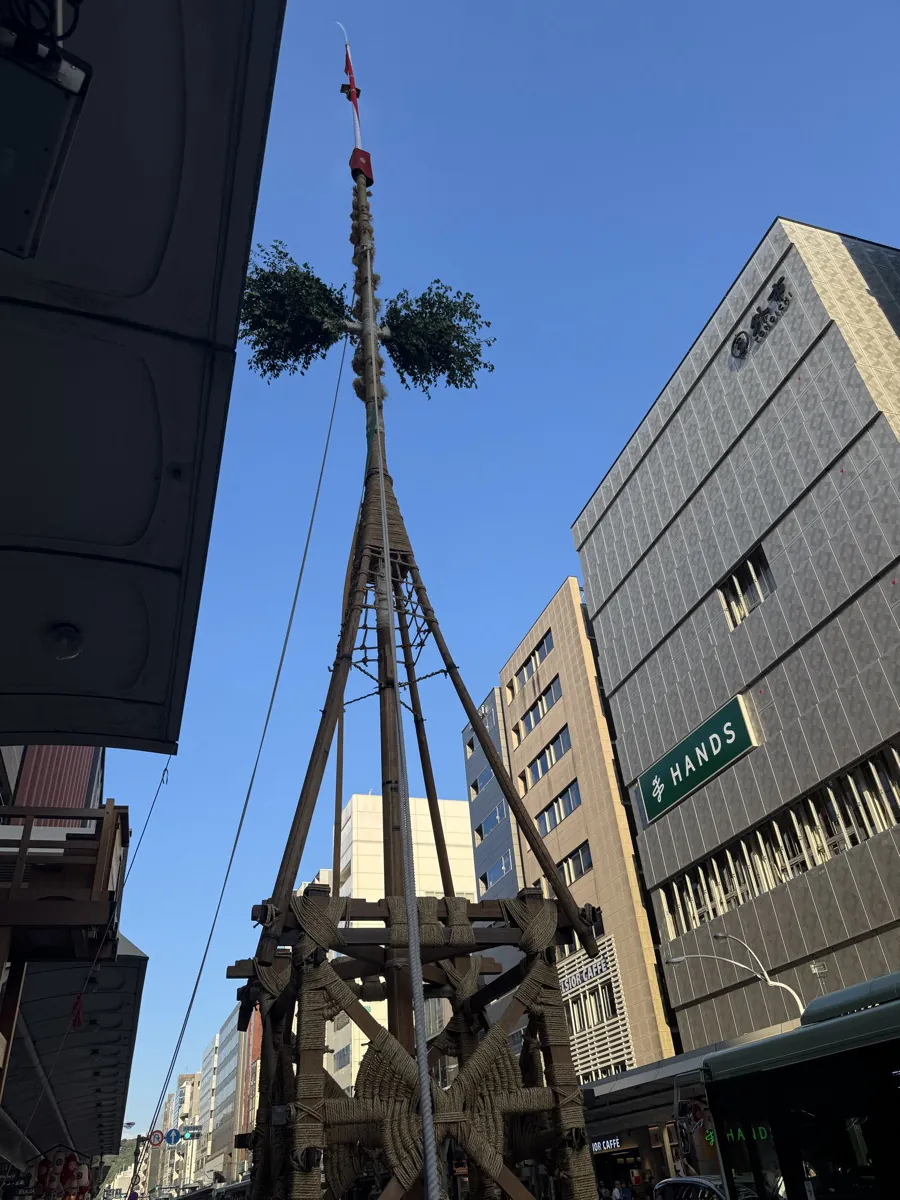 The Naginata-hoko float being assembled in the street with wood and rope during Gion Matsuri